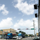On the corner of Northwest 62nd Street and Northwest Seventh Avenue in Liberty City, Miami, new high-rise developments (right) sit across the street from Rasta Paradise and Liberty City Beauty Supply stores. (Ashley Velez/The Root)